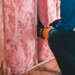 Weatherization Assistance Program contractor installing home insulation