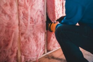 Weatherization Assistance Program contractor installing home insulation