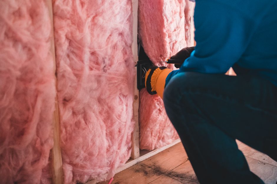 Weatherization Assistance Program contractor installing home insulation