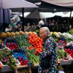 Senior shopping for fresh produce at a farmers market using SFMNP vouchers