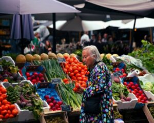 Senior shopping for fresh produce at a farmers market using SFMNP vouchers