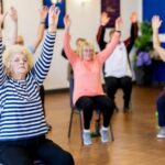 Seniors participating in a SilverSneakers fitness class at a gym