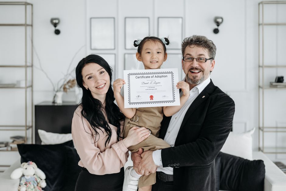 Child with adoptive parents symbolizing a completed special-needs adoption