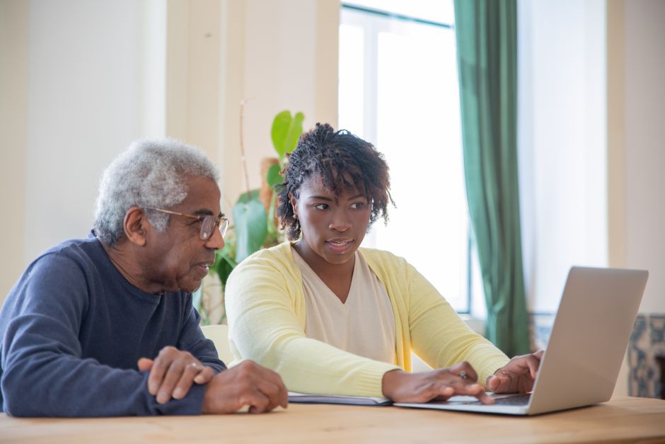 adult child helping a parent fill out a Medicare Savings Program application online