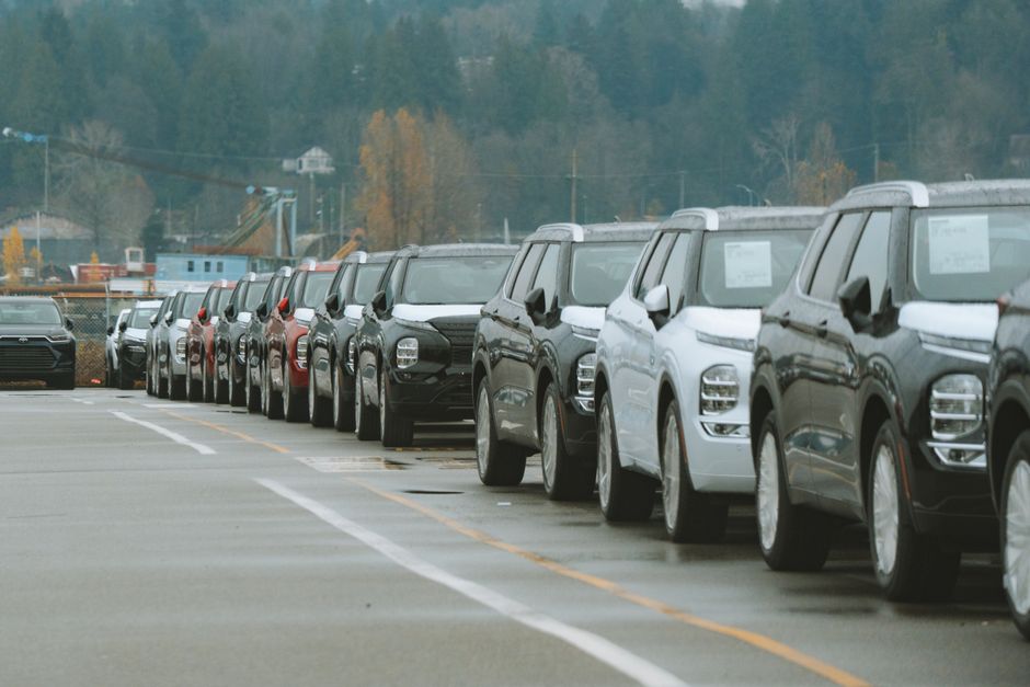 row of new cars on a dealership lot