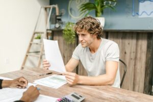 Canada Workers Benefit overview - worker reviewing pay stub and tax documents
