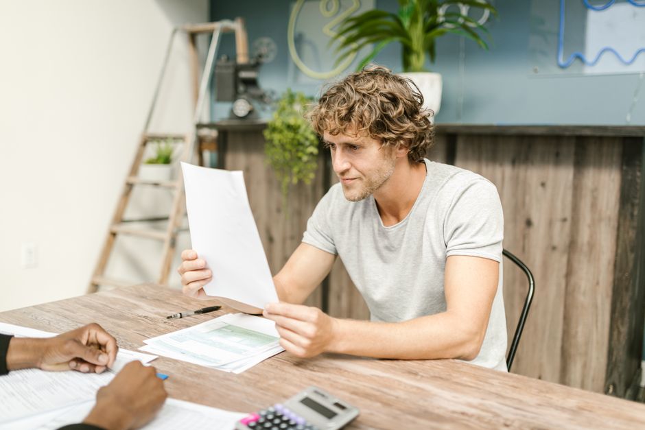 Canada Workers Benefit overview - worker reviewing pay stub and tax documents