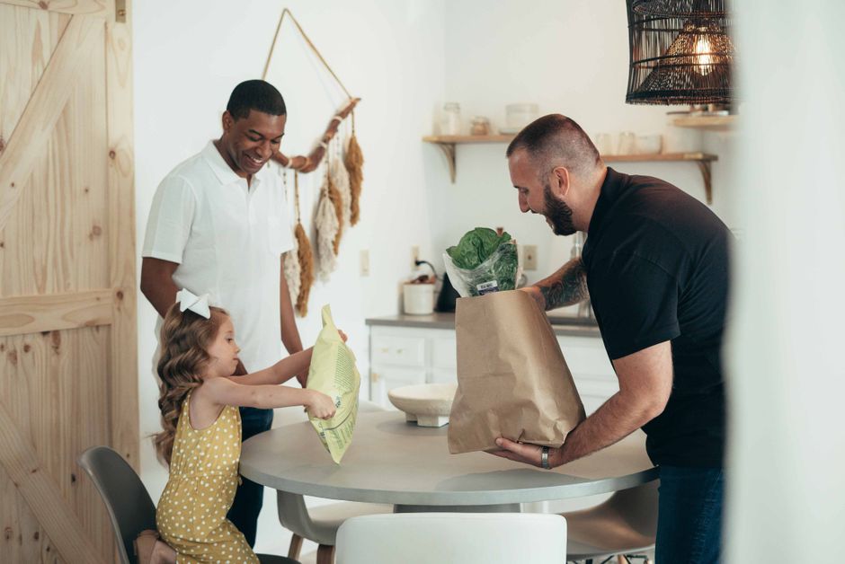 family reviewing household grocery expenses together in the kitchen