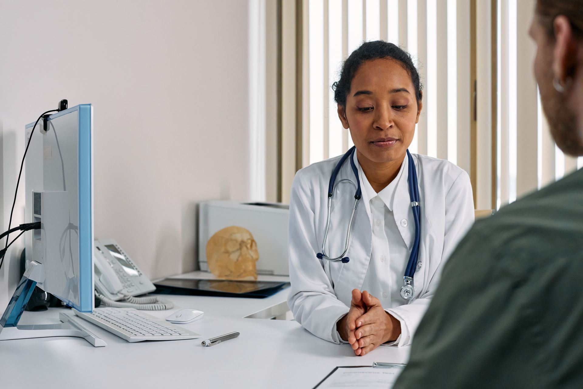 Doctor completing a medical report for a CPP Disability Benefit application with a patient