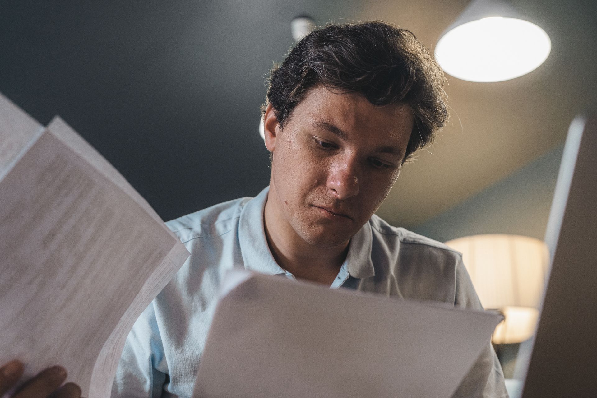 Canadian adult reviewing CPP Disability Benefit paperwork at home due to a severe medical condition