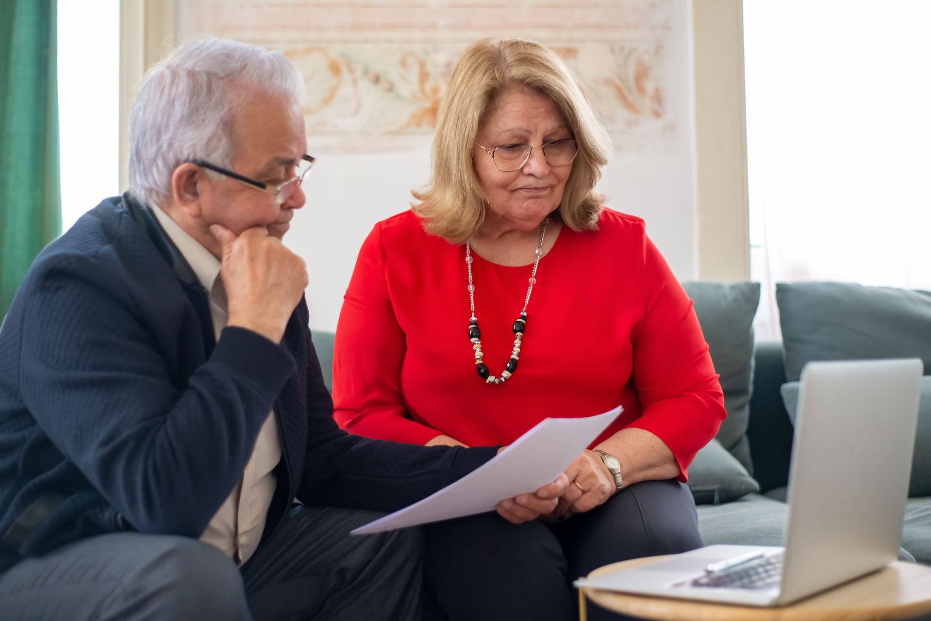 Older couple reviewing financial documents representing the automatic conversion of CPP Disability Benefit to retirement pension at 65