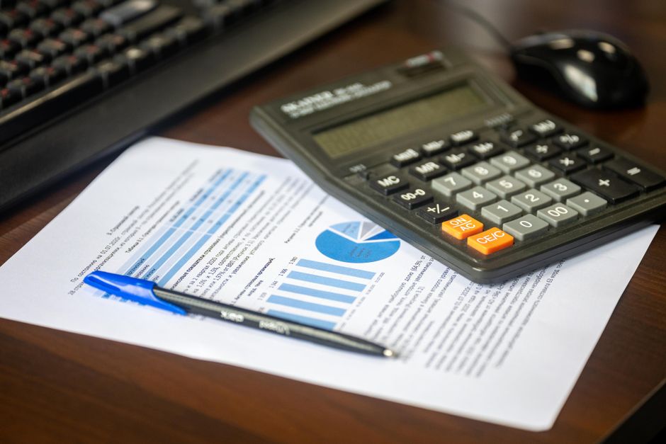 Calculator and financial documents representing family budgeting and tax refunds