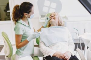 senior patient at a routine dental checkup, representing dental care coverage for seniors on Medicare