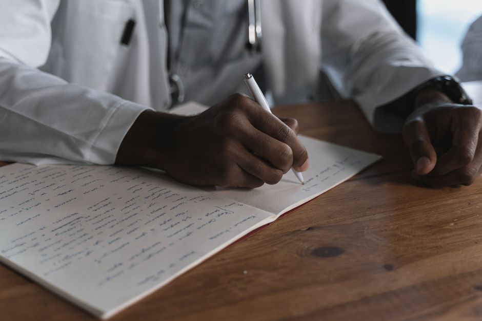 Doctor writing a letter of medical necessity for a patient