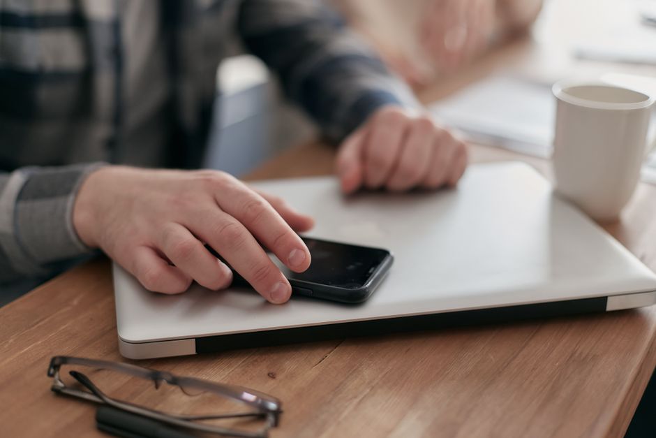 Comparing funeral home price lists on a laptop and phone