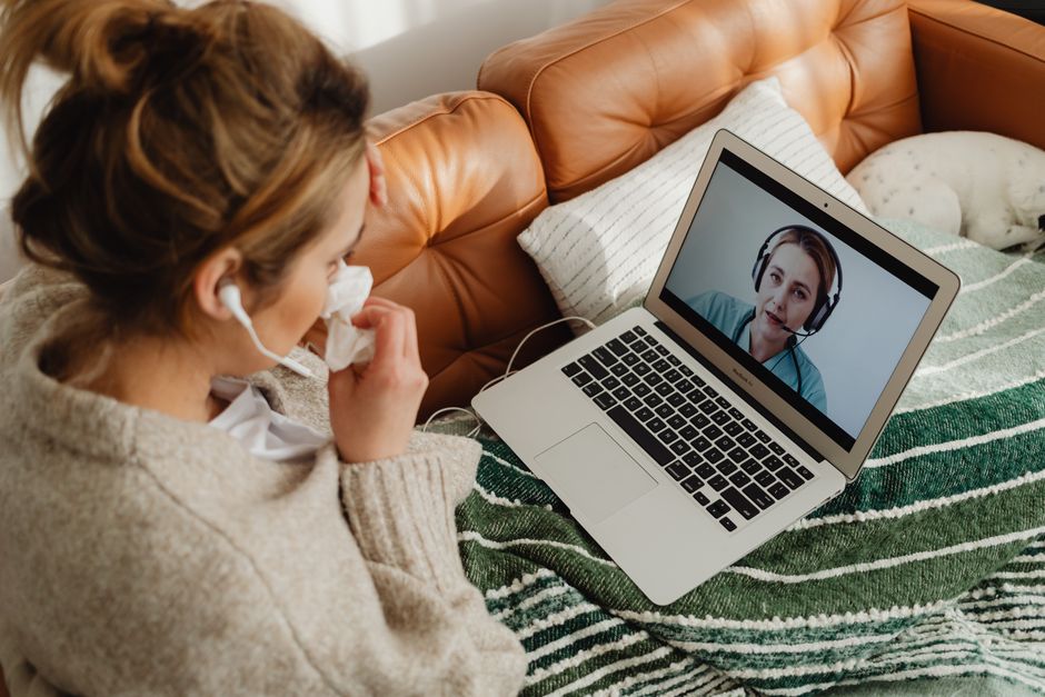 person on a telehealth video call with a doctor from home