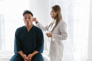 Senior having a hearing exam covered by Medicare Part B diagnostic testing