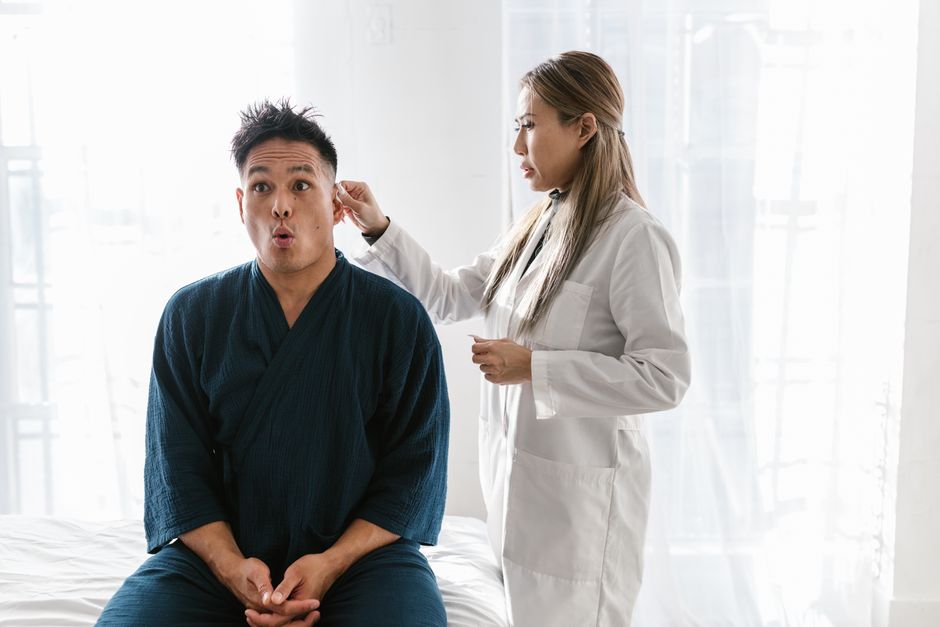 Senior having a hearing exam covered by Medicare Part B diagnostic testing