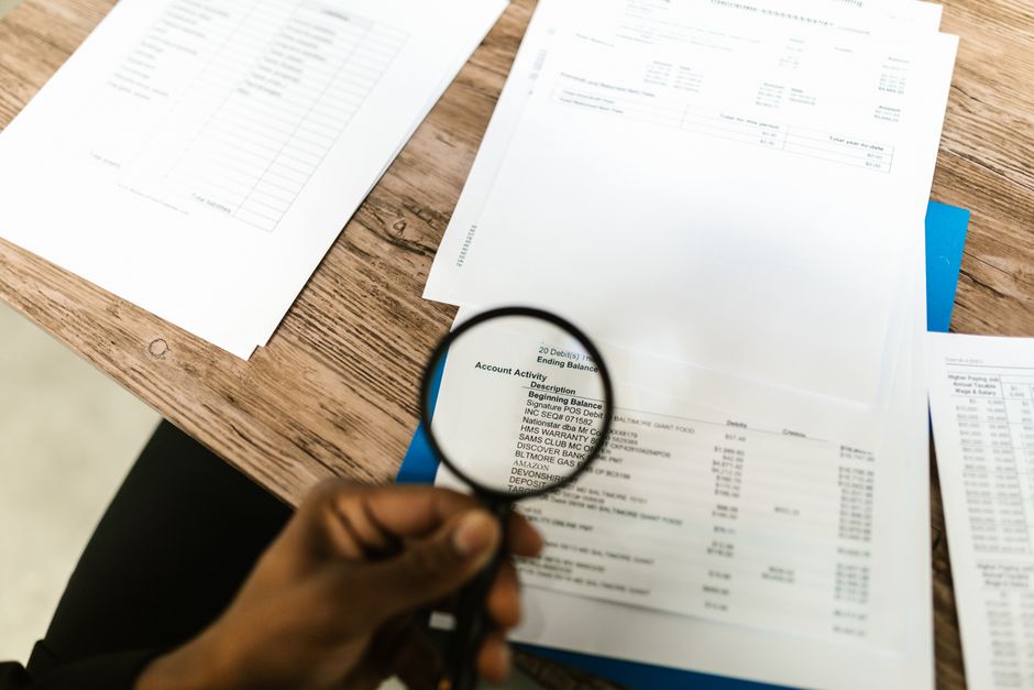 Close-up of hands reviewing an income bracket table and Medicare premium notice