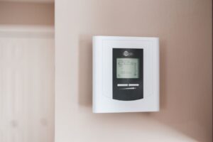 Home thermostat and utility bills representing LIHEAP energy assistance
