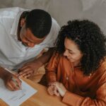 parent completing paperwork for a newborn savings account