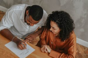 parent completing paperwork for a newborn savings account