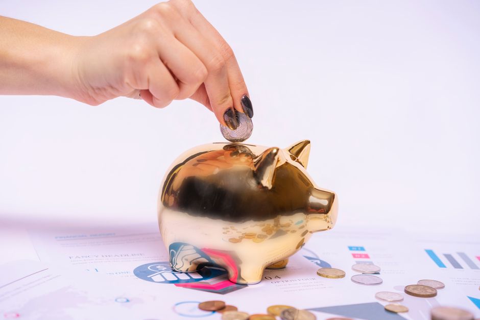 piggy bank next to financial documents symbolizing long-term savings