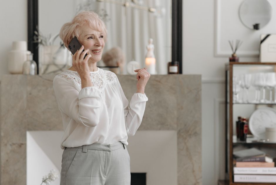 older adult on a phone call getting help from a benefits assistance helpline