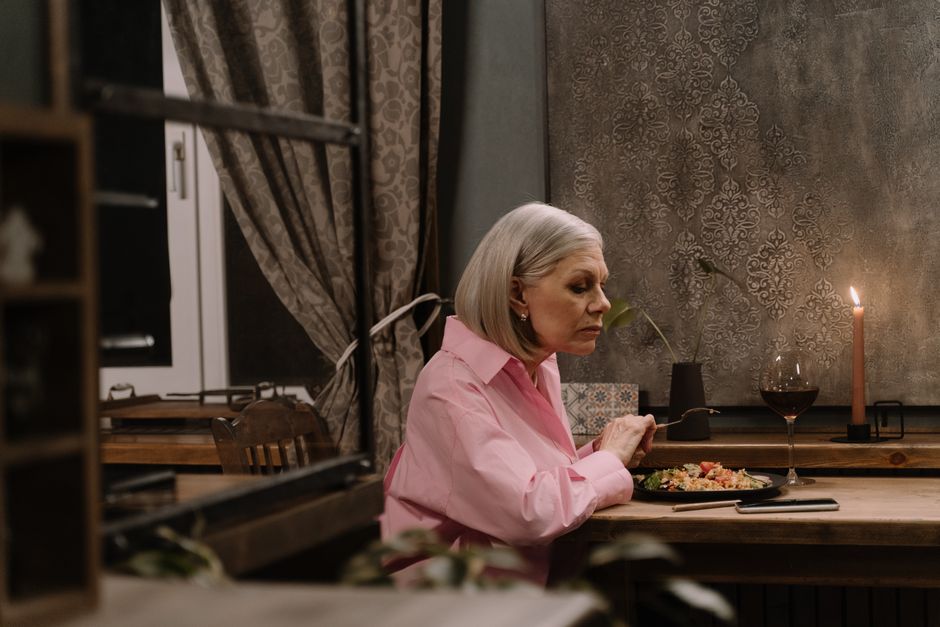 older adult sitting at the dining table enjoying a delivered meal