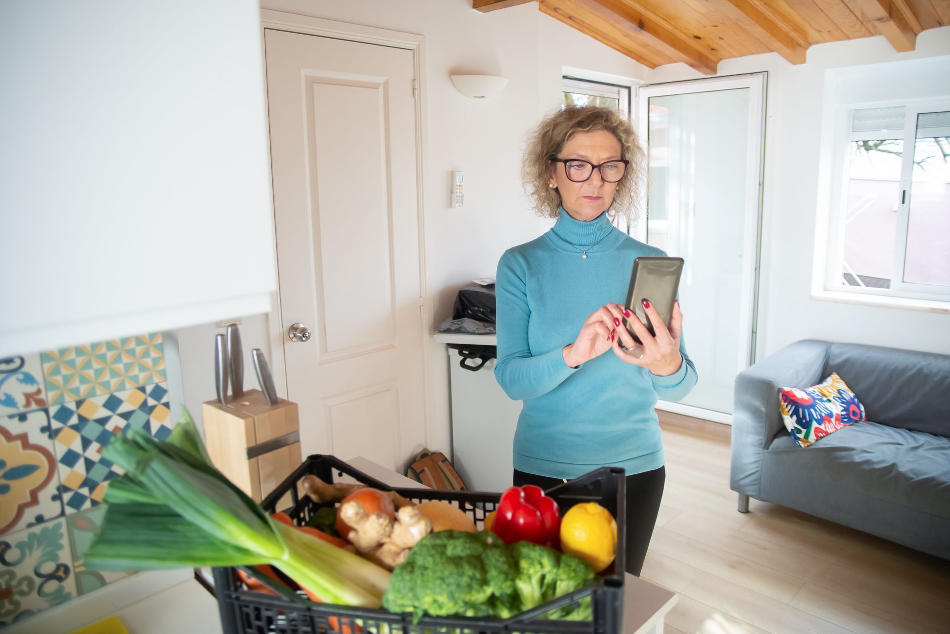 Older adult scanning a grocery receipt with a cash-back app on a smartphone