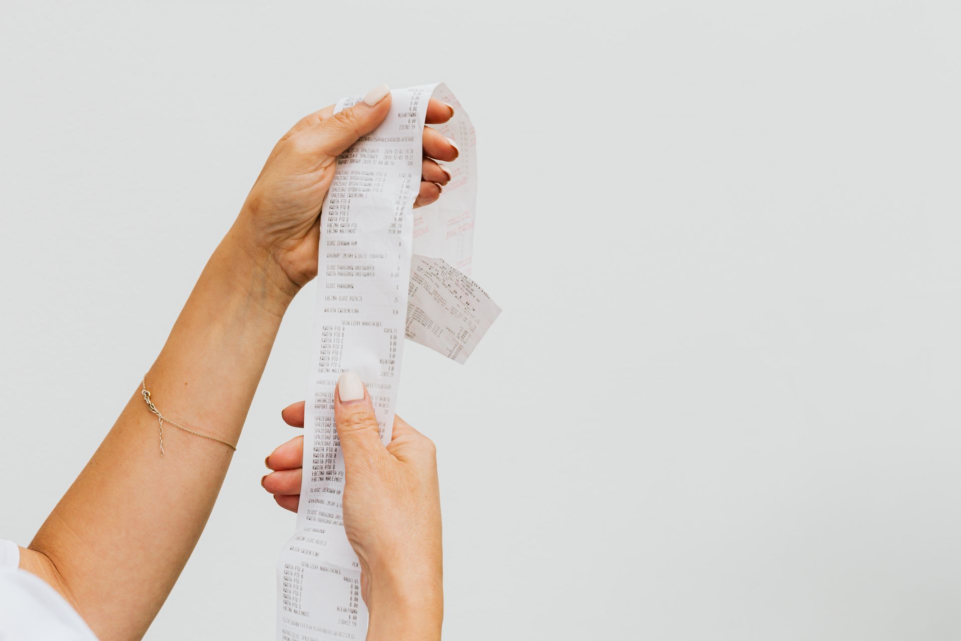 Grocery receipt, coupons, and loyalty card next to a cash-back app on a phone