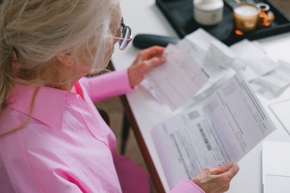 retiree reviewing IRA account statement while preparing a charitable donation form