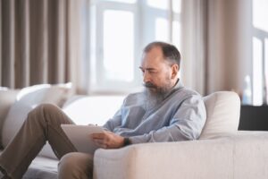 Senior reviewing savings account on tablet