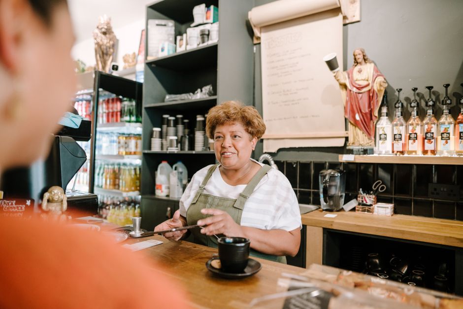 Retiree working a part-time retail job with a customer