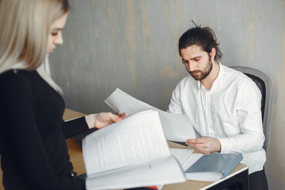 Worker reviewing retirement plan paperwork with HR staff