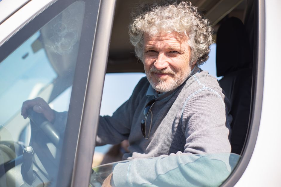 Senior driver enjoying a relaxed retirement drive with lower mileage