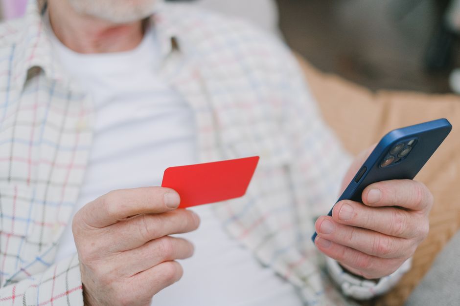 Person on the phone reviewing a credit report to set up a fraud alert