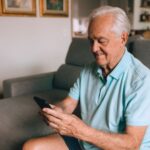 Senior adult reviewing a cell phone bill on a smartphone at home