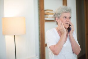 Older adult reviewing a suspicious phone call as a possible scam targeting seniors