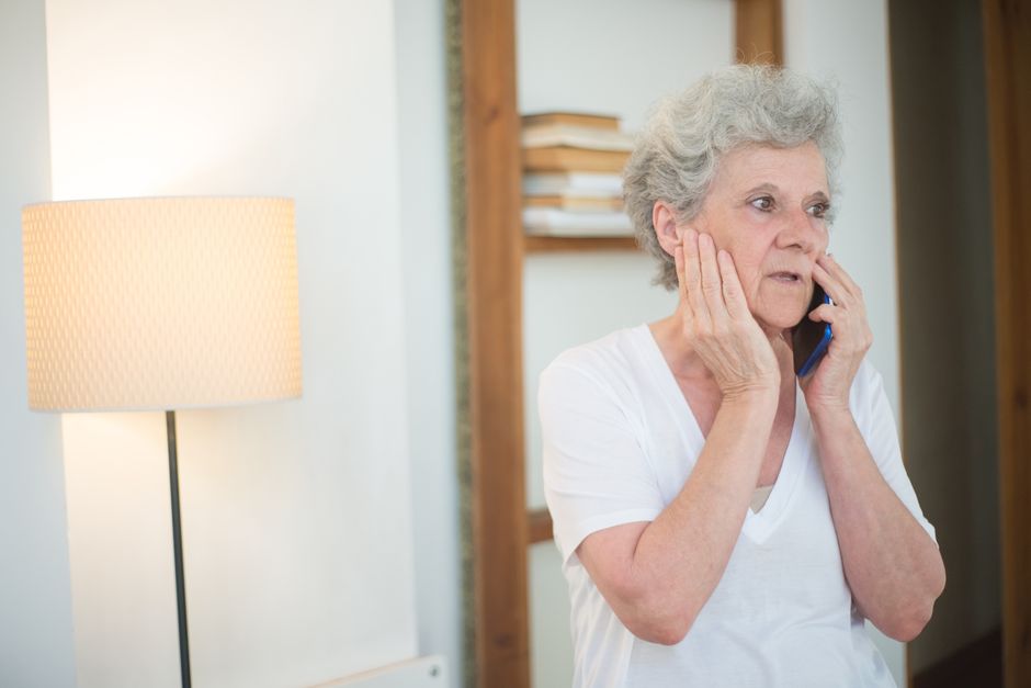 Older adult reviewing a suspicious phone call as a possible scam targeting seniors