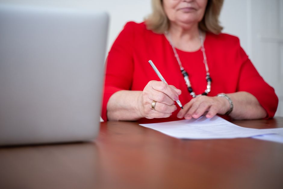 Senior homeowner filling out USDA home repair grant application paperwork