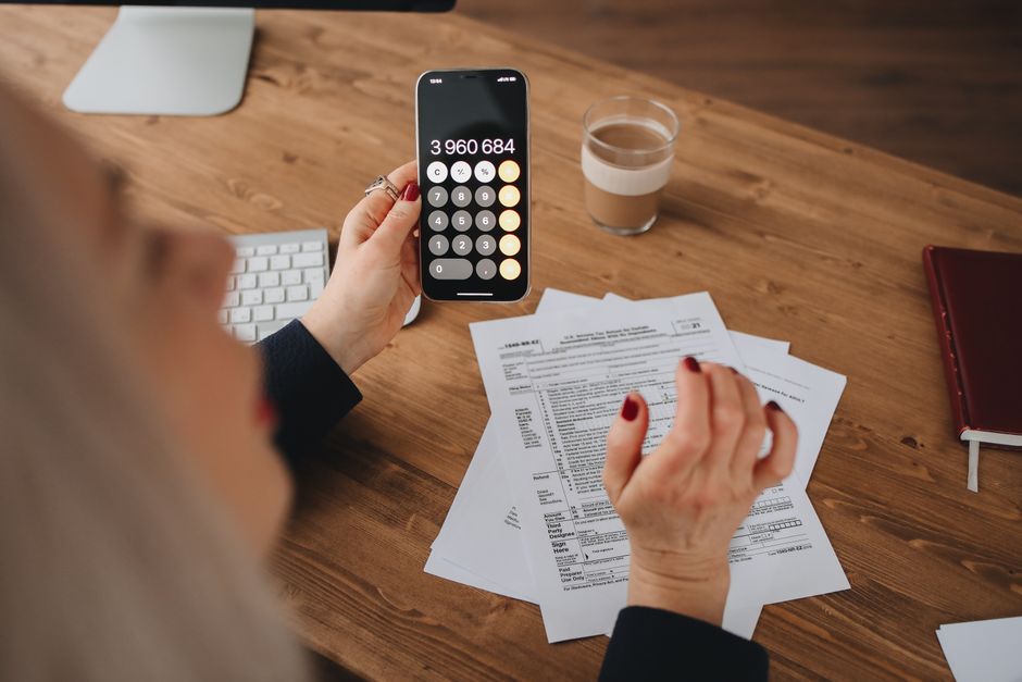 Person reviewing homeowners insurance paperwork while on the phone