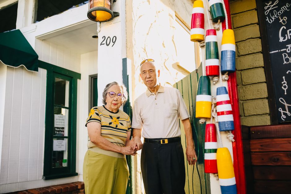Senior New York homeowners in front of their house discussing property taxes