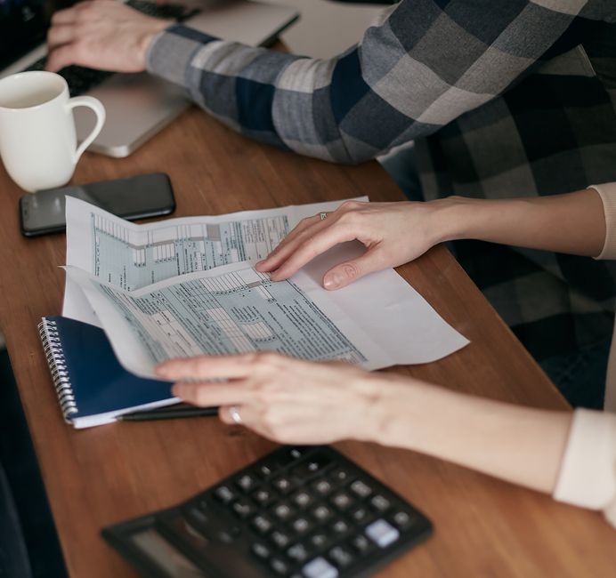 Hands reviewing a New York property tax bill with a calculator