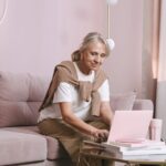 Older adult checking Amazon Prime Access eligibility on a laptop