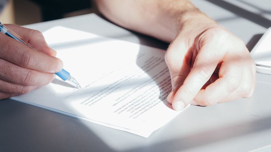 hands filling out Texas Form 50-114 homestead exemption application