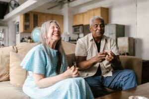 Senior couple reviewing their AARP membership card and benefits at home