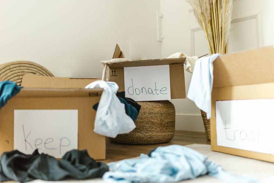 Furniture and boxes staged for a home decluttering and resale project