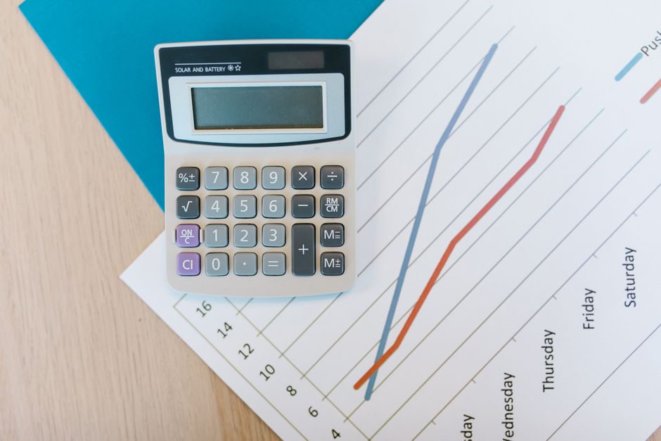 Calculator and retirement savings growth chart on a desk