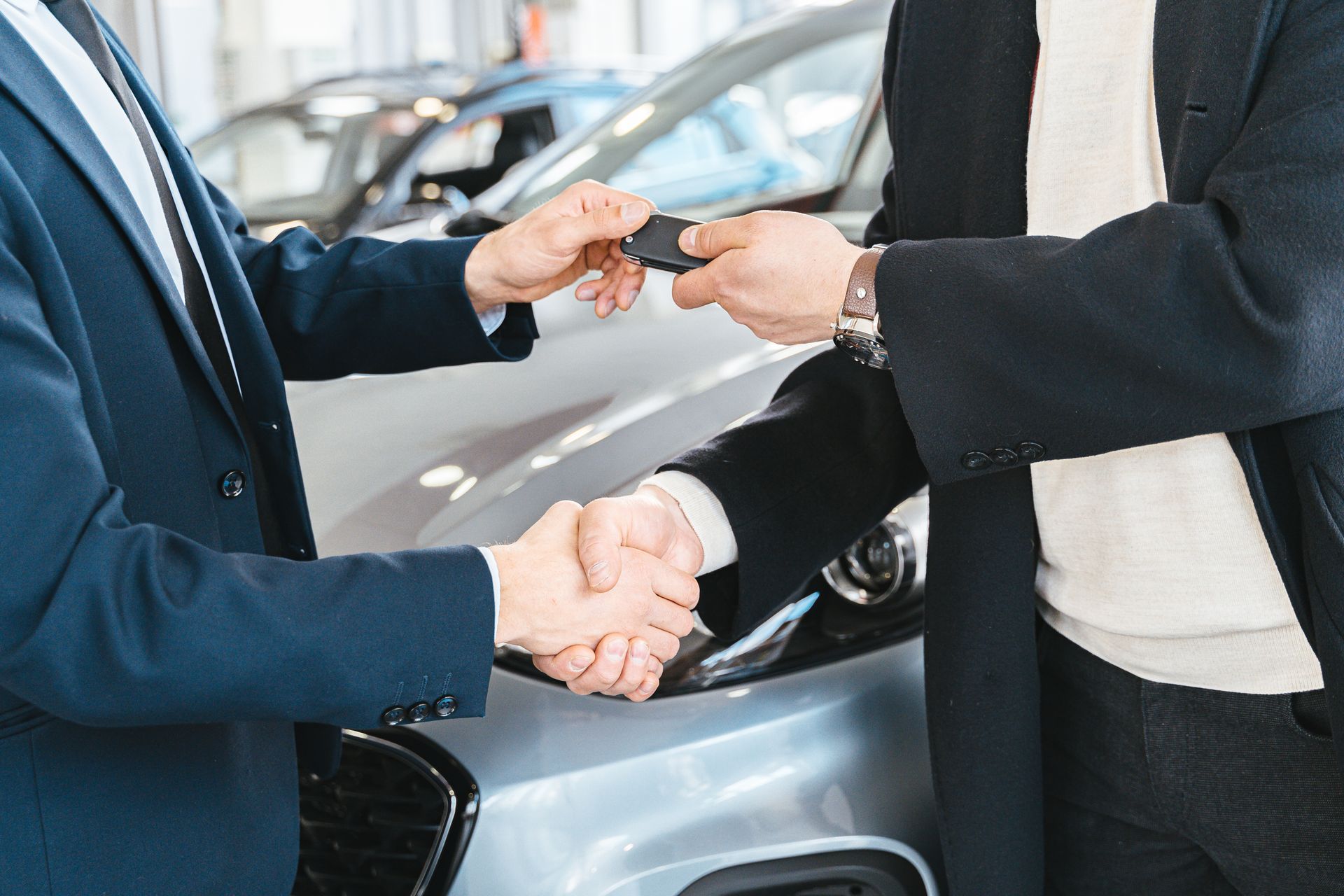 Handing over car keys after completing a purchase through the AARP Auto Buying Program